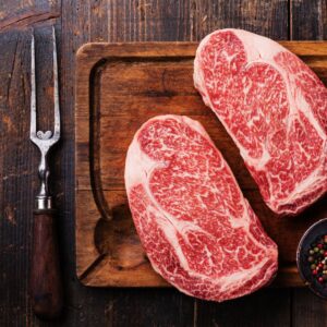 two steaks on a cutting board