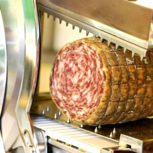 roll of meat in a meat slicer